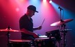 © lian - Drummer playing drums during live performance on stage with colorful lighting. High quality
