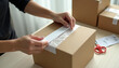 © universal Stockist - Sealing a Shipping Box – Hands in E-Commerce Packaging Action