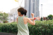 © Jirawatfoto - Asian woman fitness workout and yoga stretching exercise reduces shoulder pain inflammation muscle strain and injury risk. Medical wellness in an urban city part of healthcare at sunset