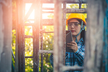 Wall Mural - Young female project manager supervising construction work at residential building project.