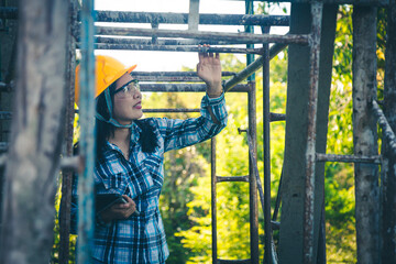 Wall Mural - Young female project manager supervising construction work at residential building project.