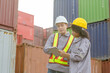 © JU.STOCKER - Engineer and foreman worker team in hardhat and safety vest checking containers box from cargo, Engineers with tablet managing cargo operations, Teamwork concepts