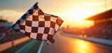 Chequered flag waving at race track finish line against sunset. Winning symbol, racing car competition, auto sport, victory, championship. Race car rally at finish.