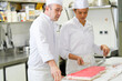 © auremar - pastry chef and apprentice decorate a cake
