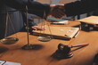 © Kansuda - Attractive young lawyer in office Business woman and lawyers discussing contract papers with brass scale on wooden desk in office. Law, legal services, advice, Justice and real estate concept.
