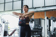 © Phimwilai - Asian woman lifting kettlebell during fitness training in gym