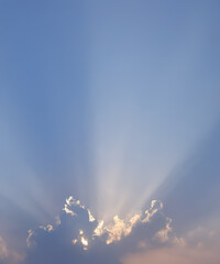 Wall Mural - Sunbeam through the haze on blue sky, vertical
