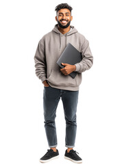 young indian man with beard, wearing gray casual hoodie and jeans, standing with laptop under his ar
