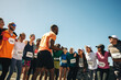 © Jacob Lund - Group of runners in a pre-race pep talk session outdoors
