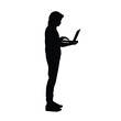 © adidesigner23 - Silhouette of a hacker holding and using a laptop while standing