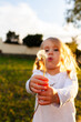 © Austockphoto - Backlit little girl with messy hair blowing dandelion seed head to make a wish
