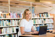 © Austockphoto - portrait of Aboriginal Australian woman in her twenties at library using laptop to study tafe course