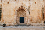 Gothic entrance of the Ciutadella de Menorca Cathedral are presented, featuring its iconic archway and historic stone. This prominent religious landmark is a part of Menorca cultural heritage