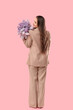 © Pixel-Shot - Pretty young woman with lilac flowers on pink background, back view