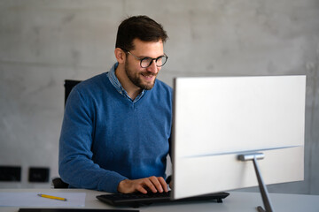 Success young professional businessman investor,manager at workplace working on computer in office