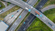 © Artinun - Aerial view of modern highway interchange with autonomous vehicles and connectivity symbols. Smart traffic systems and 5G technology for future transportation and intelligent mobility solutions.