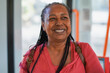 © Sabrina - Happy senior african woman smiling on camera inside bus - Travel, vacation and elderly person concept