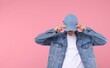 © New Africa - Young man wearing stylish denim baseball hat on pink background, space for text