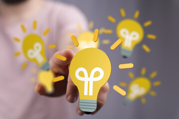 Aufkleber - Hand holding glowing lightbulb,creative ideas, innovation, solutions, brainstorming, success.