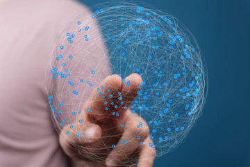 Leinwandbilder - Abstract image of a hand interacting with a digital sphere representing global network connections.