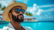 © Alex Alex - A smiling man with a dark beard, sunglasses and a straw hat. It is set against a backdrop of bright blue sea and rocky shores with green trees. Rest and travel.