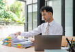 © Nittaya - Young Man Working with Documents at Desk