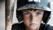 © Pinklife - A focused young boy, wearing a helmet and gripping a baseball bat, showcases determination and seriousness, embodying the spirit of teamwork and athleticism in sports.