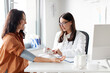© Home-stock - Young female doctor with tonometer measuring middle aged woman patient's blood pressure at hospital during consultation and checkup