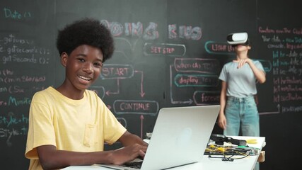 Smart african student programming and coding innovative system while caucasian girl enter in metaverse or virtual world by using VR or head set at blackboard in STEM technology classroom. Edification