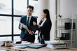 © Wicitr - Business Professionals Reviewing Documents in Office