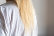 © Vikto - Soft blonde hair resting on a white cotton T-shirt shoulder, shot in natural light. Great for beauty, hair care, or minimalist lifestyle visuals.