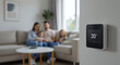 © NN AI - Smart thermostat showing 20 degrees with blurred family sitting on couch in living room. Digital temperature display mounted on wall with home interior background. Climate control technology