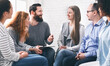 © Prostock-studio - Professional help. Psychotherapist talking with patients during support group meeting, panorama