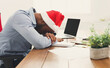 © Prostock-studio - Sleep at work. Tired african-american businessman with laptop dreaming after Christmas party in modern white office interior, copy space