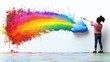 © kossafi - Creative girl paints colorful rainbow from blue cloud on white wall in bright room studio