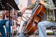 © Наталья Майшева - Musicians sitting on stage perform a live cello and violin duet, showcasing their musical talent. The players focus intently, adding a dynamic atmosphere to the performance.