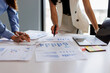 © David - Financial analysts analyze business financial reports on a digital tablet planning investment project during a discussion at a meeting of corporate showing the results of their successful teamwork.