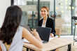© David - Two asian lady colleagues discussing new project, business asian women using digital tablet together in office