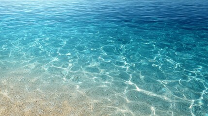 Poster - Overhead view of vibrant blue tropical ocean water with sunlight rippling through, faint sand visible, and spacious copy area on the left