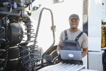 Aufkleber - Truck repair service. African american Mechanic makes computer diagnostic of the semitruck