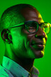 © Pixel World Vision  - Profile of an adult man with glasses against a vibrant green backdrop featuring thoughtful expression and soft lighting