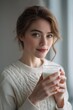 © Iryna - Young caucasian female enjoying a glass of milk in cozy sweater