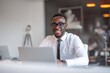 © ttonaorh - Young smiling businessman working on a laptop in the office.