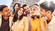 © Davide Angelini - Multiracial friends having fun on citu street  - Group of young people laughing together outdoors - Friendship concept with guys and girls hanging outside on a sunny day