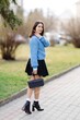 © nazariykarkhut - Fashionable student posing in a park during a sunny spring day