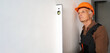 © Andrii Lysenko - repair, building and home renovation concept. Senior male builder with spirit level measuring wall