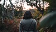 © LesaMurina Coll - Back view of a person walking in a field towards the sunset