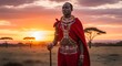 © Richafuji - Woman in Traditional Attire at Sunset in African Savanna. Red and White Clothing with beaded jewelry and warm tones. Golden hour sunlight bathes the landscape, illuminating the trees.