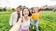 © Davide Angelini - Happy friends taking selfie picture outdoors - Group of young people having fun together at the park - Youth community and people concept