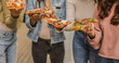 © PintoArt - Friends sharing pizza slices, enjoying a casual meal together